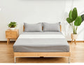 Grounding fitted sheet set on a made bed