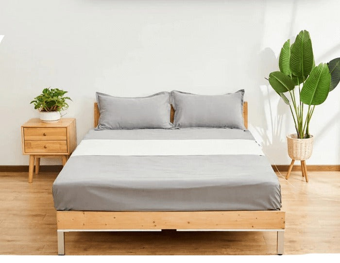Grounding fitted sheet set on a made bed